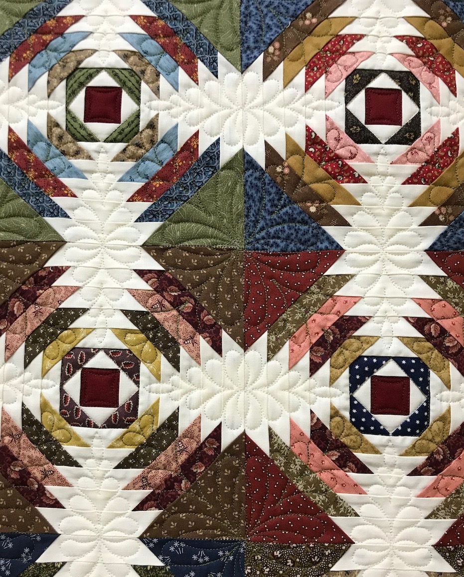 Detailed longarm quilting on a pieced quilt